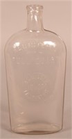 S.C. Miller Liquors Embossed Clear Quart Flask.
