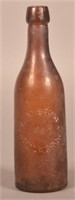 A.M. Bryden Embossed Dark Amber Blob Top Bottle.