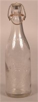 H.W. Grimecy Embossed Clear Blob Top Bottle.