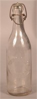 Schmitt & Beilman Embossed Clear Blob Top Bottle.
