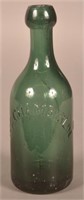 W.C. Chamberlin Embossed Dark Green Water Bottle.