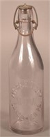 Myers E. Wiley Embossed Clear Blob Top Bottle.