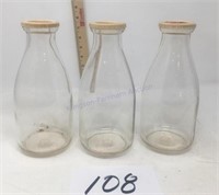 Three vintage unmarked quart milk bottles