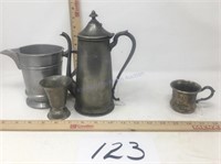Pewter pitchers and cup with a silver plated cup