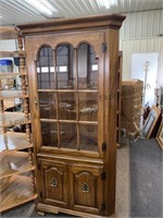 Lighted corner cabinet with glass shelves. Note