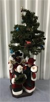 CHRISTMAS FIGURINES ON BASE OF SMALL TREE