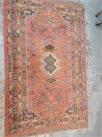 Oriental style area rug measures 58" x 37"