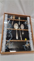 DISPLAY CASE WITH SPOONS AND FORK