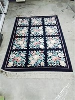 Kara Stan 4x6 ft area rug with blue background