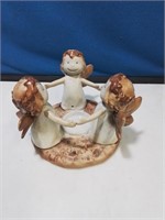 Pottery angels dancing around a tea light candle