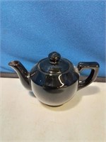Very dark brown or black teapot