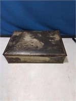 Vintage metal storage box with sheep in a pasture