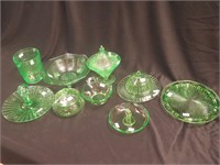 Nine pieces of green Depression glass, all glow: