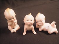 Three Lefton bisque kewpie figurines,.