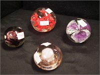 Four colorful crystal paperweights: two signed