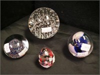 Four crystal paperweights: one egg-shaped,