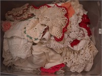 Container of vintage linens including doilies,