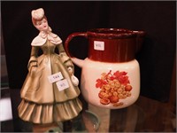 Figurine of woman in period clothing marked