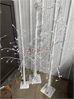 3 decorated lighted trees