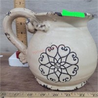 Pottery pitcher with brown design