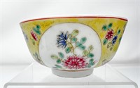 Chinese etched floral bowl with yellow glaze.
