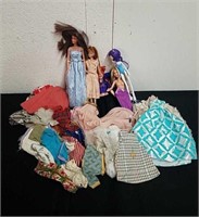Group of Barbie dolls and clothes