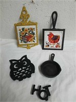 Cast iron trivets and a small frying pan