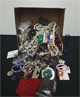 Box of miscellaneous jewelry and a flashlight