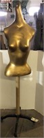 GOLD COLORED MANNEQUIN ON STAND
