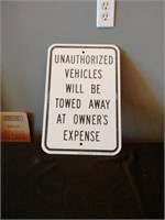Unauthorized vehicles will be towed away sign