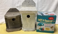 2 wooden bird houses and a twirl in squirrel