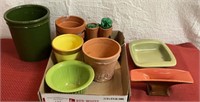 Flat with small clay pots in a few ceramic flower