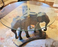 V - GLASS TOP TABLE W/ ELEPHANTS BASE (R15)
