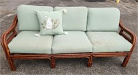 Vintage Dark Rattan Sofa w/ sage green cushions