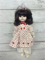 Porcelain doll with heart dress and stand