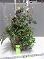 Faux floral arrangement in a wire basket