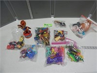 Bags of assorted toys, some include dinosaurs, veh