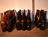 29 early brown beer bottles: 22 Schlitz, 7 unmarke