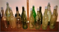 15 early glass bottles: Old Quaker, Pluto Water, G