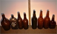 8 early large brown glass bottles; as is