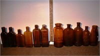 11 early brown glass bottles, tallest 8"h; as is
