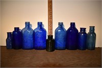 9 early mostly blue glass medicine bottles, talles
