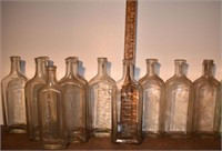11 early clear glass bottles: Watkins, Raleigh's;