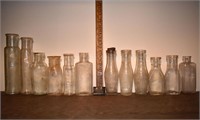 12 early clear glass bottles, tallest 10"h; as is
