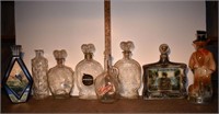 8 early whiskey decanters: 3 ceramic Beam and 5 gl