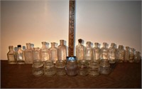 23 early small clear glass bottles and jars, talle