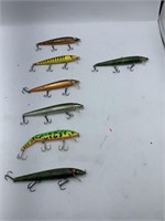 Seven fishing lures and plastic divided fishing