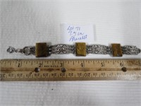 7.5 bracelet with etched faces on settings