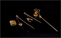 Four antique yellow gold stick pins