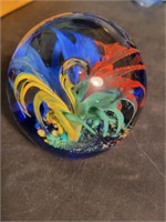 Clear art glass paperweight with multi-colored